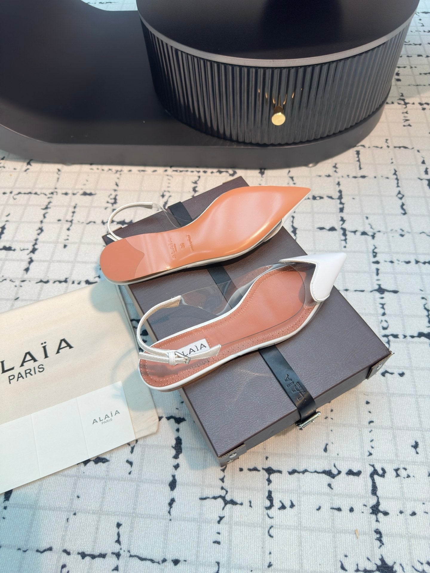 ALAIA FLAT SLINGBACK IN WHITE PATENT CALFSKIN AND FILM