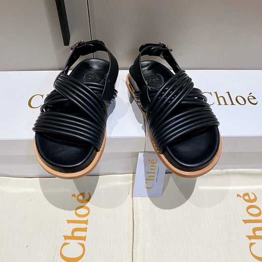 CROSS STRAP SANDAL IN BLACK RUBBER WITH GOLD HARDWARE