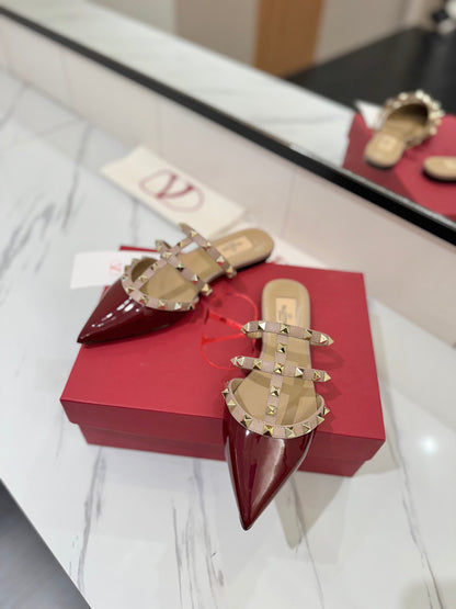 VALENTINO 26S STUDDED FLAT MULES IN DARK RED PATENT CALFSKIN