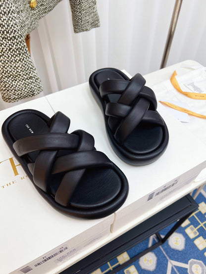 THE ROW 26S CROSSED PADDED SLIDES IN BLACK CALFSKIN