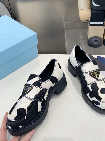 PRADA 26S LOAFERS IN WHITE AND BLACK COW PRINT PONY HAIR