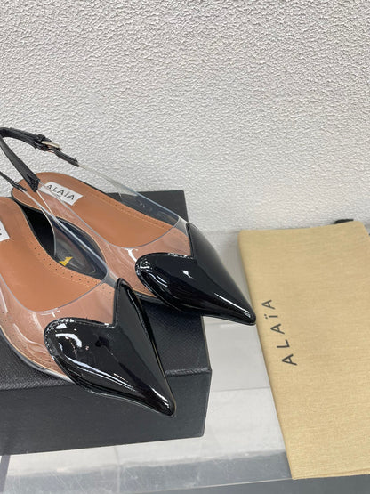 ALAIA LE COEUR FLAT SLINGBACKS IN BLACK PATENT LAMBSKIN
