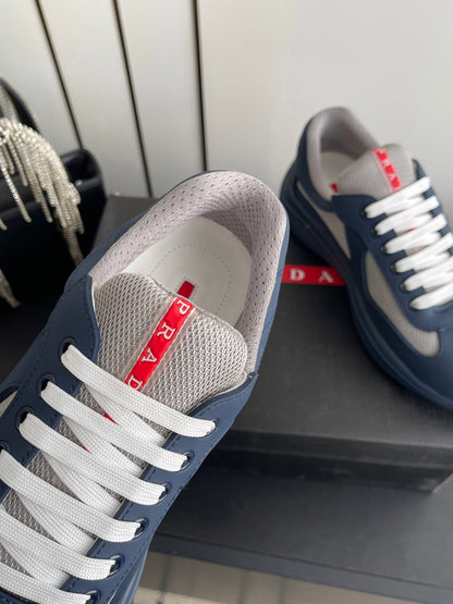 PRADA 26S AMERICA CUP SNEAKERS IN SLATE BLUE SOFT RUBBER AND BIKE FABRIC
