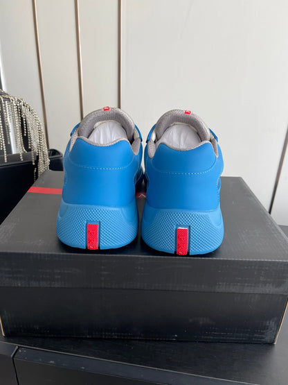 PRADA 26S AMERICA CUP SNEAKERS IN AZURE BLUE SOFT RUBBER AND BIKE FABRIC