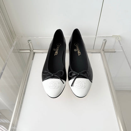 CHANEL 26S BALLET FLATS IN BLACK CRACKED CALFSKIN WITH WHITE TOE CAP AND BOW